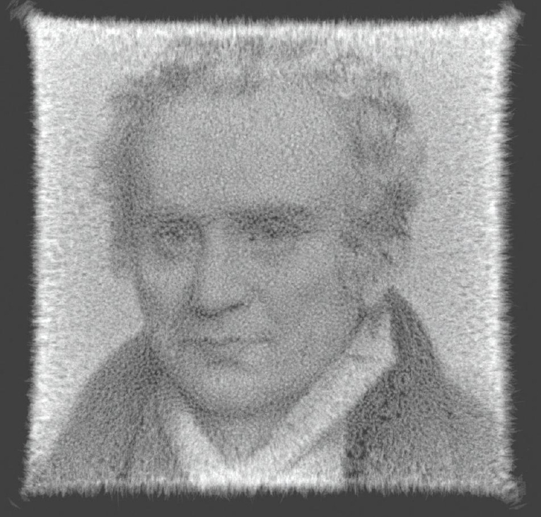 Grainy grayscale portrait of a man with long hair and a dark coat, surrounded by a bright, textured rectangular border.